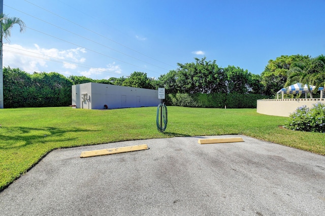 view of car parking with a yard