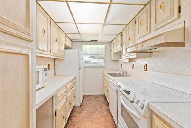 kitchen featuring tile patterned floors, decorative backsplash, cream cabinetry, sink, and white appliances