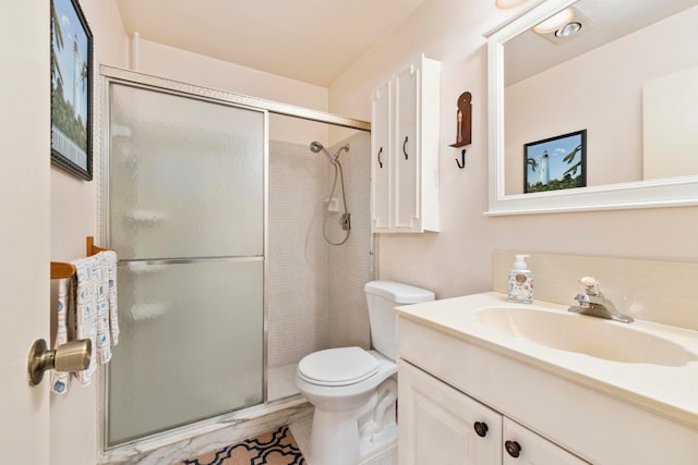 bathroom with vanity, toilet, tile patterned floors, and walk in shower