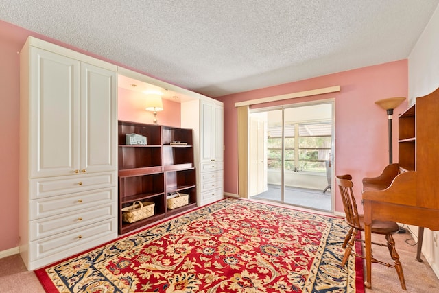 carpeted office space featuring a textured ceiling