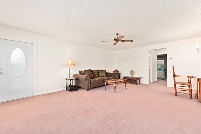 carpeted living room with a textured ceiling and ceiling fan