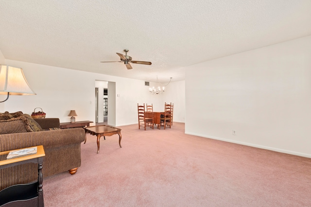 carpeted living room with a textured ceiling and ceiling fan with notable chandelier