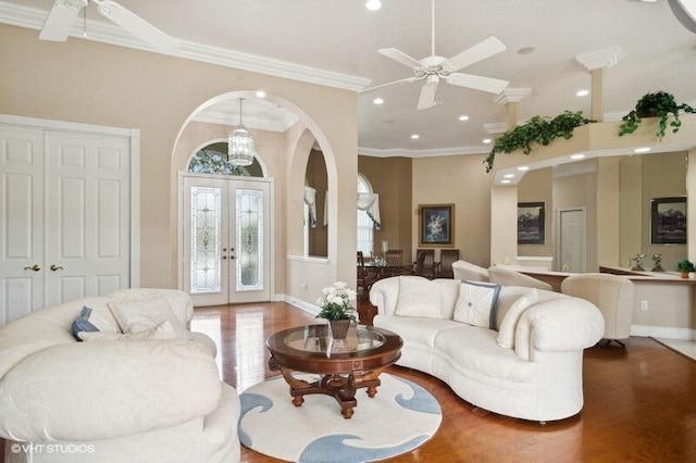 living room featuring french doors, crown molding, and ceiling fan