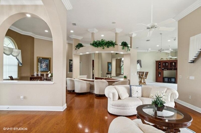 living room with crown molding, ceiling fan, and dark hardwood / wood-style flooring