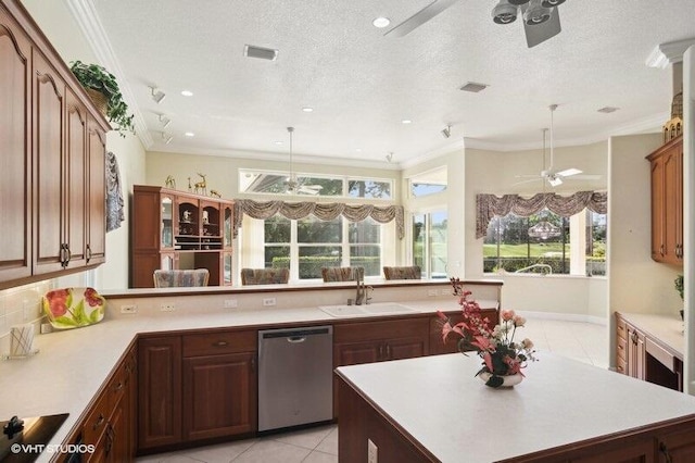 kitchen with sink, a textured ceiling, decorative light fixtures, stainless steel dishwasher, and crown molding