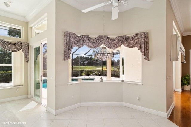 tiled empty room with ornamental molding and ceiling fan