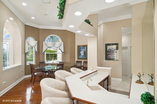 interior space featuring crown molding, hardwood / wood-style flooring, and sink