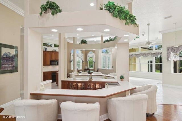 dining space featuring light hardwood / wood-style floors, ornamental molding, ceiling fan, and a wealth of natural light