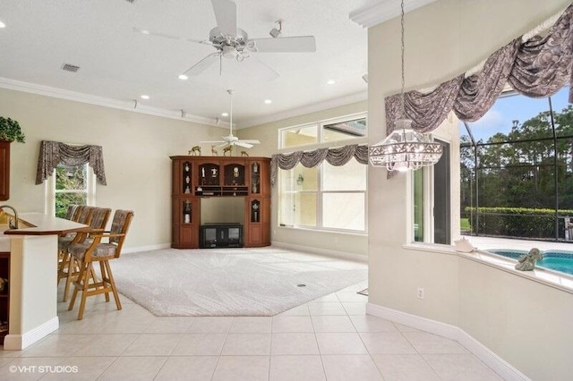 tiled dining space featuring ornamental molding and ceiling fan