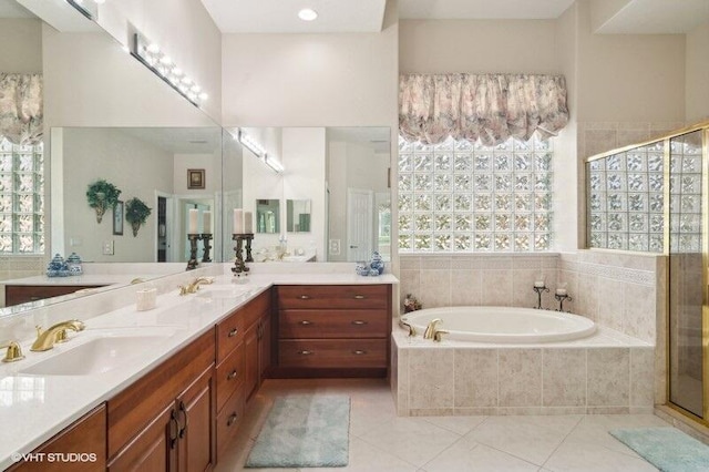 bathroom featuring vanity, independent shower and bath, and tile patterned flooring