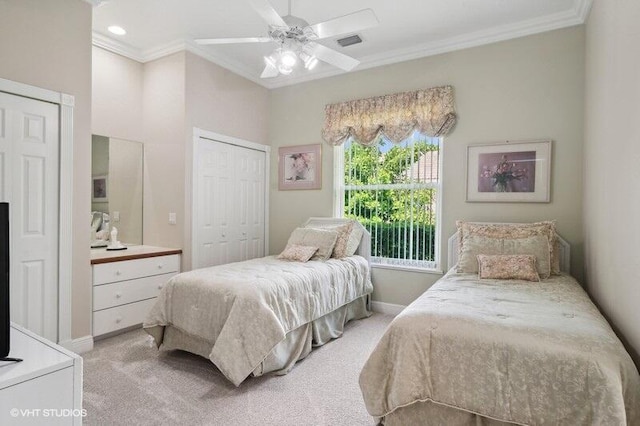 carpeted bedroom with ornamental molding, a closet, and ceiling fan