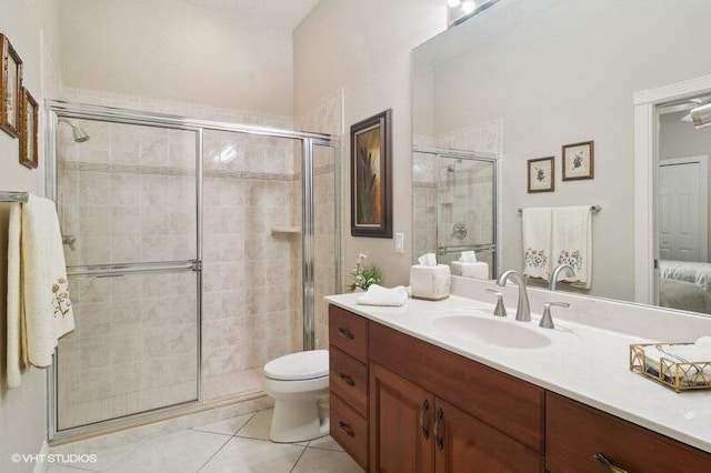 bathroom with vanity, walk in shower, toilet, and tile patterned flooring