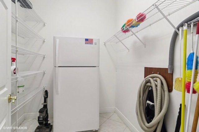 spacious closet with light tile patterned floors