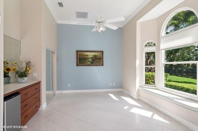 interior space featuring crown molding, a healthy amount of sunlight, and ceiling fan