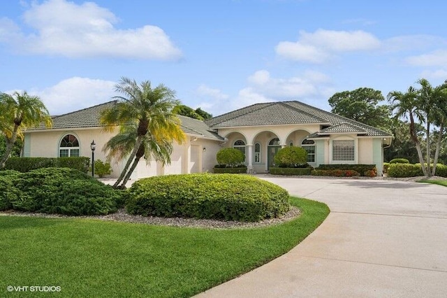 mediterranean / spanish-style house with a front lawn