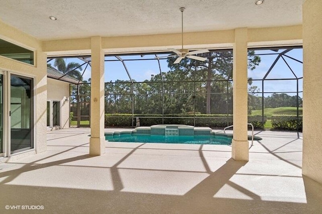 view of swimming pool featuring an in ground hot tub, ceiling fan, a patio area, and a lanai