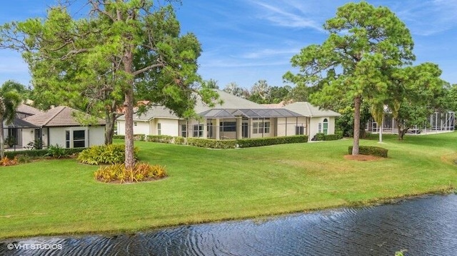 view of home's community with a yard and a water view