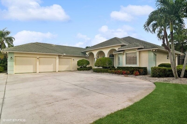 mediterranean / spanish-style house with a front lawn and a garage