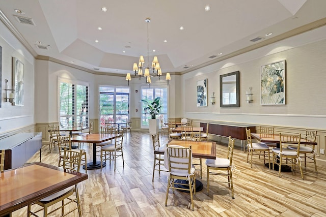 dining room featuring a raised ceiling, light hardwood / wood-style floors, and a notable chandelier