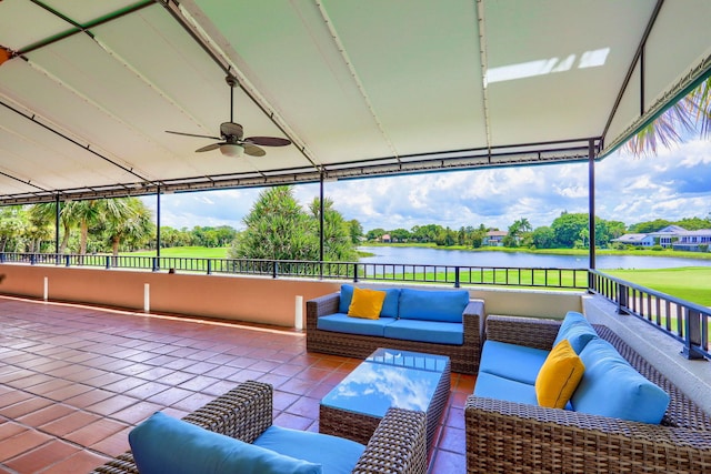 unfurnished sunroom featuring a water view and ceiling fan