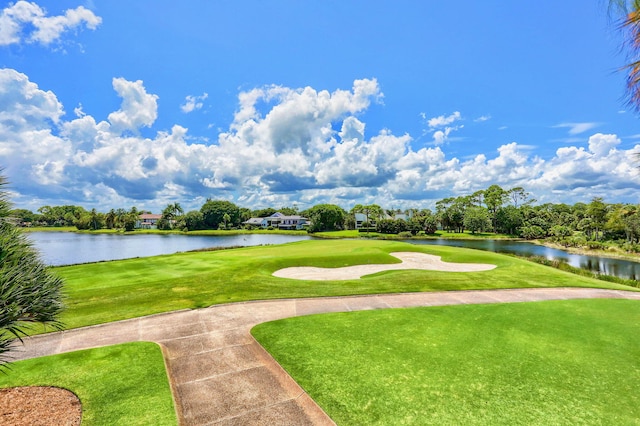 surrounding community featuring a lawn and a water view