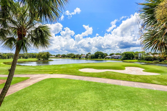 surrounding community featuring a water view and a yard