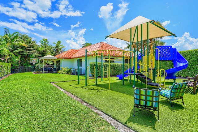 view of playground featuring a lawn and central air condition unit