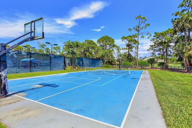 view of basketball court featuring a yard