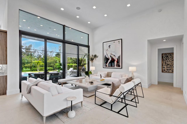 living room featuring a towering ceiling