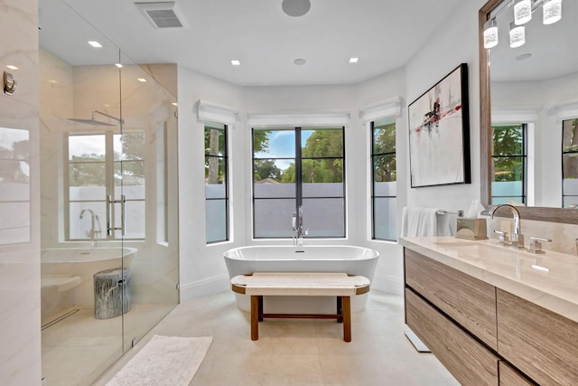 bathroom with vanity and independent shower and bath