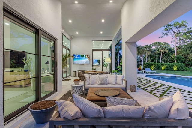 view of patio with an outdoor living space and a fenced in pool