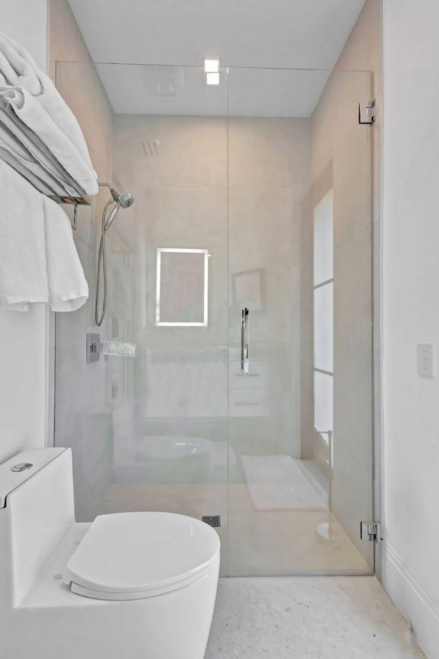 bathroom with walk in shower and toilet