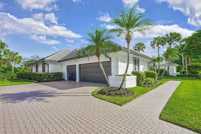 view of front of property featuring a front lawn and a garage