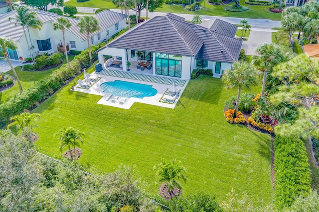 view of pool featuring a lawn and a patio