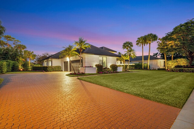 ranch-style house featuring a lawn