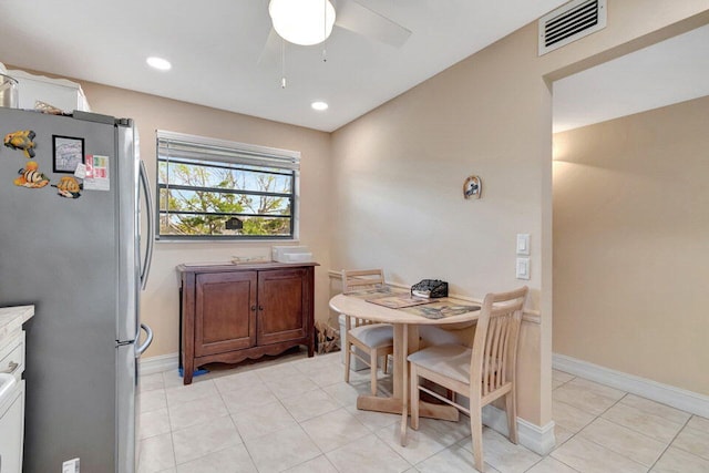 dining space featuring ceiling fan and light tile patterned flooring