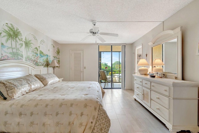 bedroom featuring a closet, a textured ceiling, access to exterior, and ceiling fan