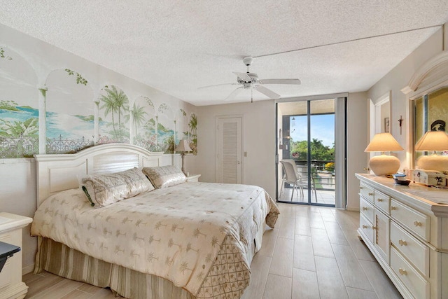 bedroom with a closet, ceiling fan, a textured ceiling, and access to exterior