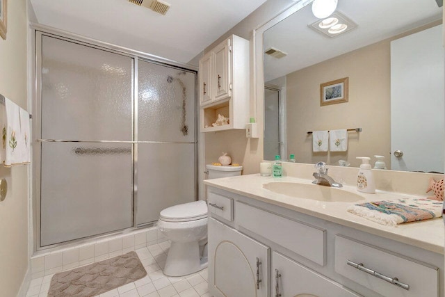 bathroom featuring vanity, toilet, tile patterned floors, and a shower with door