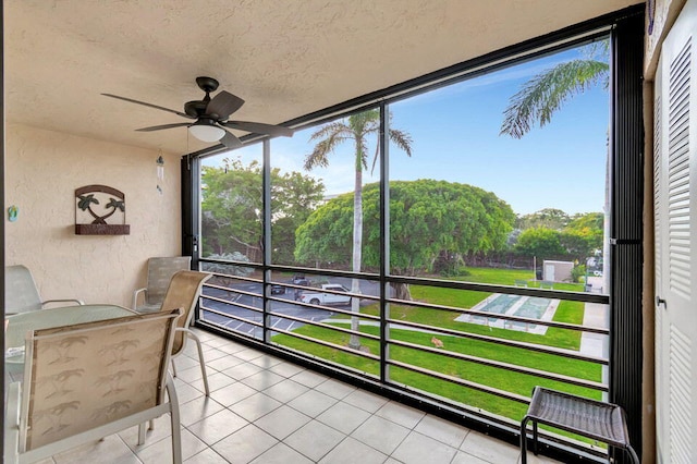 sunroom / solarium featuring ceiling fan