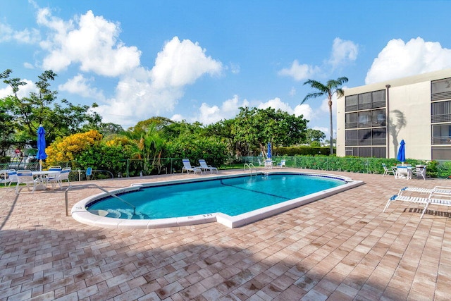 view of swimming pool with a patio