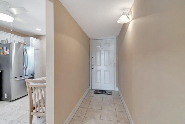 interior space with ceiling fan and light tile patterned floors