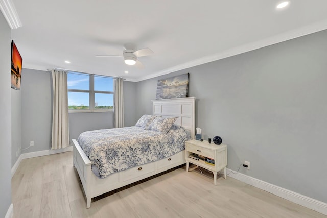 bedroom with ceiling fan, ornamental molding, and light hardwood / wood-style floors