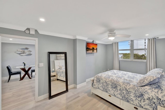 bedroom featuring light hardwood / wood-style flooring, ornamental molding, and ceiling fan