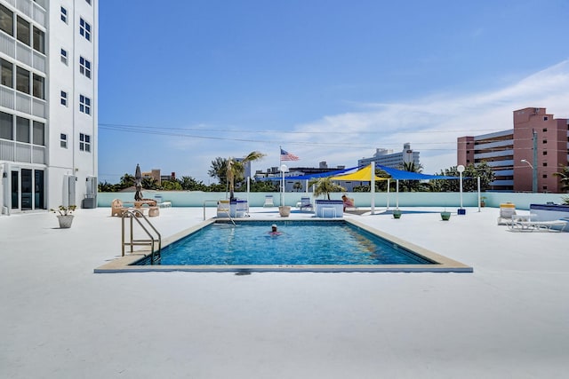 view of swimming pool featuring a patio area