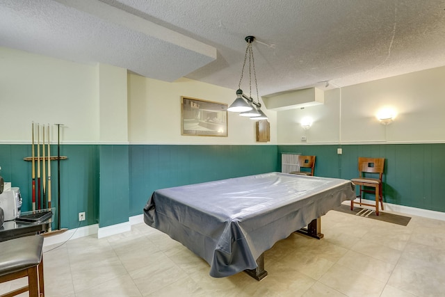 game room with pool table and a textured ceiling