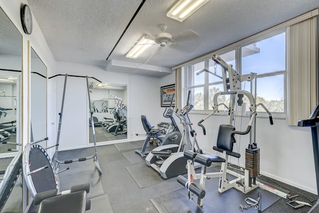 gym featuring ceiling fan and a textured ceiling