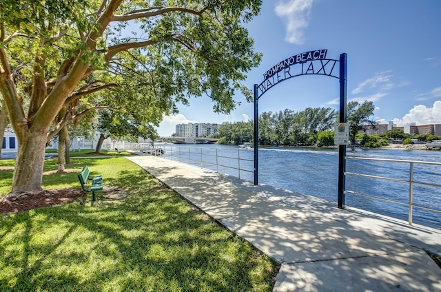 view of property's community featuring a water view and a yard