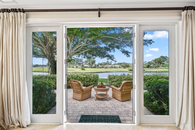 4 Country Rd, Village Of Golf, FL 33436 - entryway featuring light tile patterned flooring and a water view