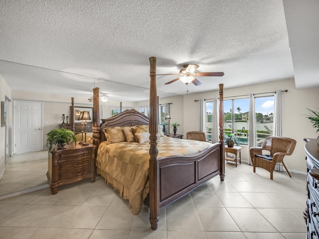 tiled bedroom featuring ceiling fan and a textured ceiling